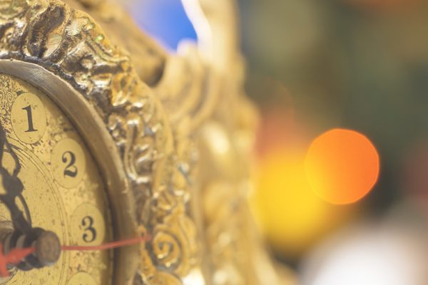 Gold clock almost at midnight - New Year's Eve ideas for singles