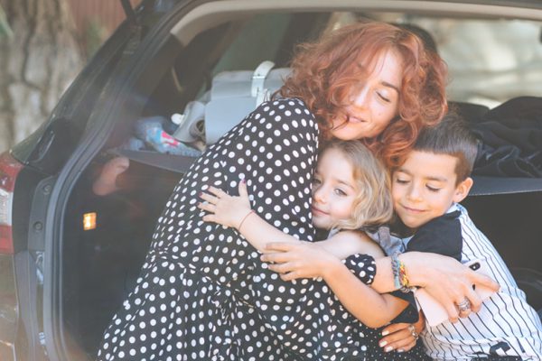 happy mum hugging kids who has Tips For Moving On Following Separation