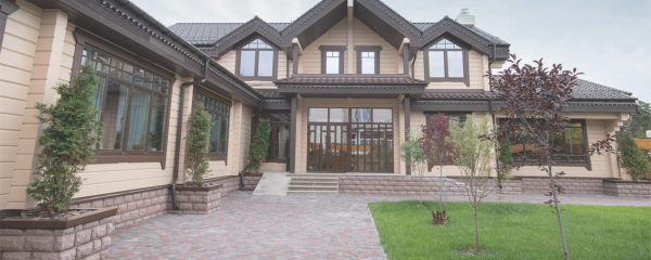 large home with driveway and grass outside
