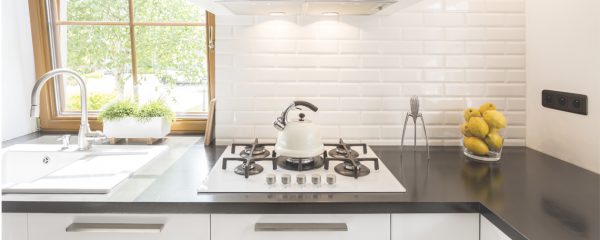 updating the kitchen on a budget - white kitchen with black worktops