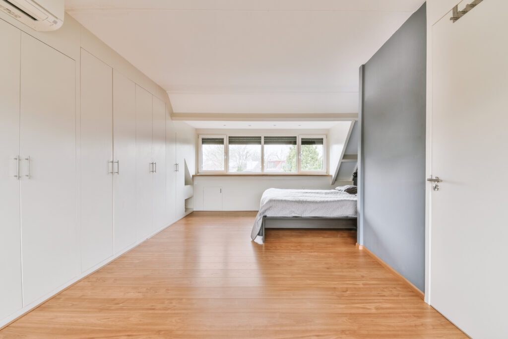 Dated bedroom with sloped fitted wardrobes. Find out are sloped ceiling wardrobes practical here