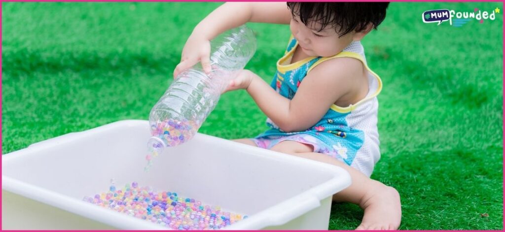 Summer Sensory Play Ideas for toddlers - toddler playing with water beads